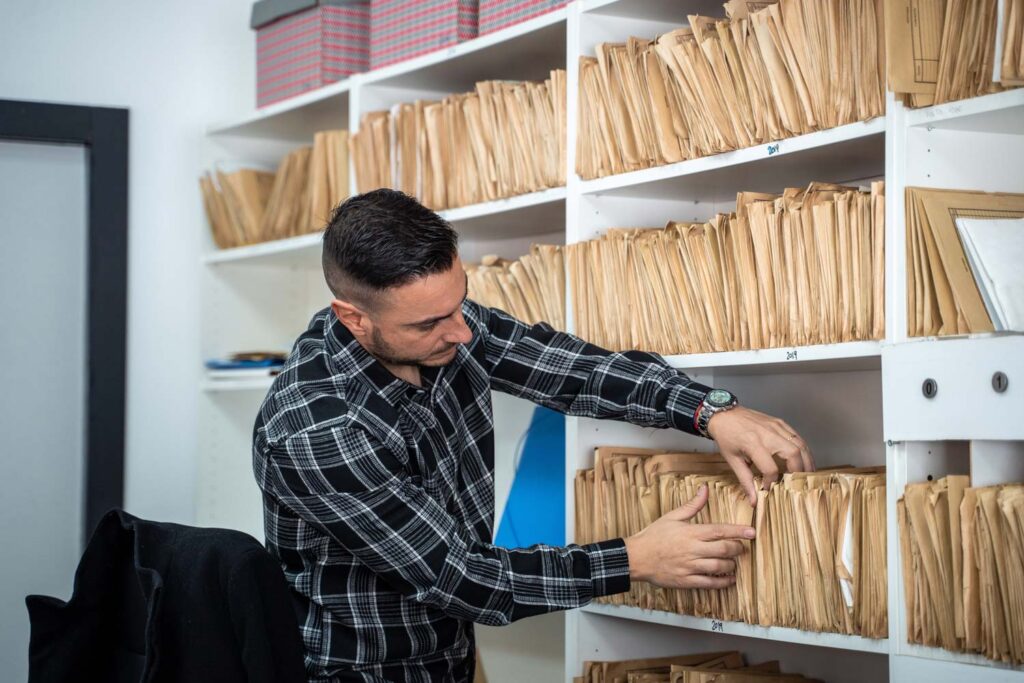 man searching through files