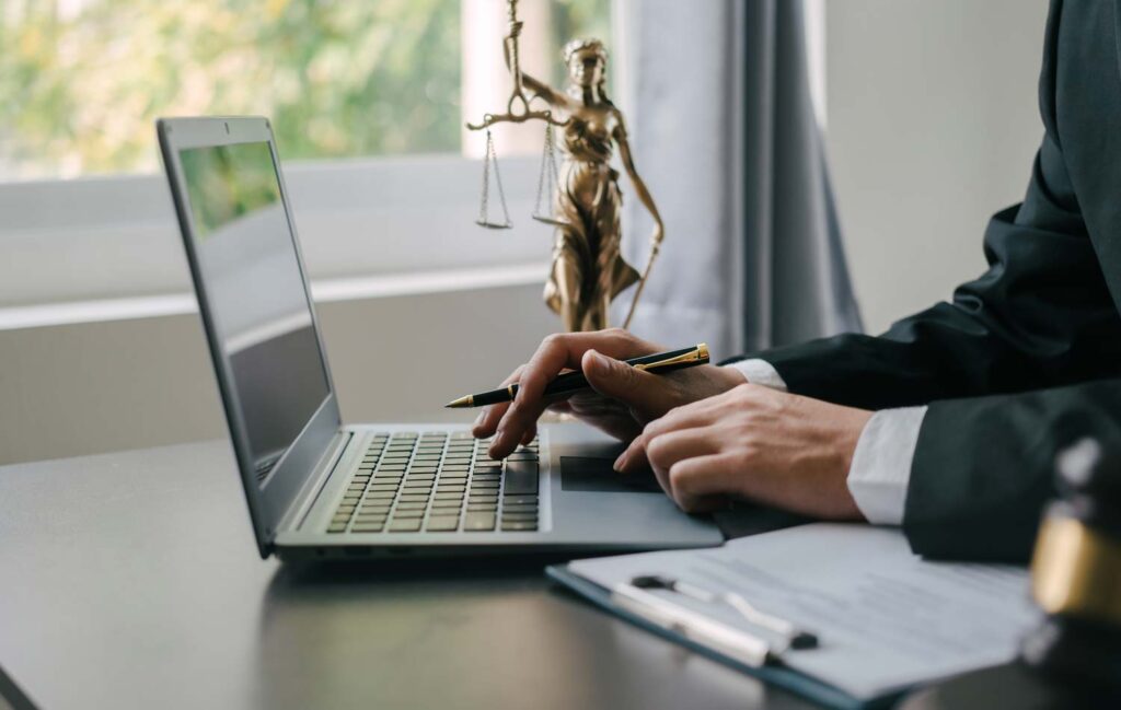 man searching legal advice on a laptop